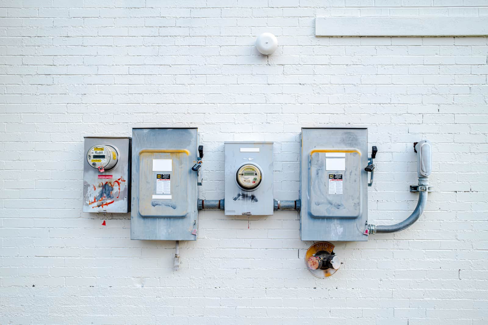 An electricity meter mounted on an exterior wall