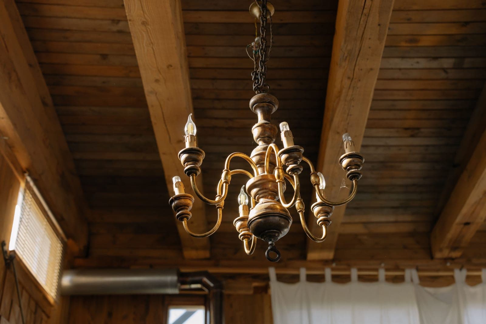A light fixture suspended from a ceiling on an adjustable chain