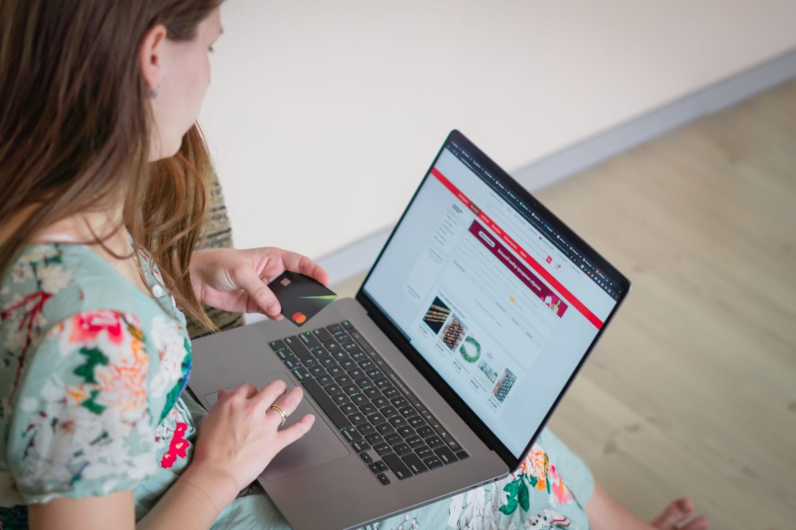 A person shopping online with a laptop and a credit card