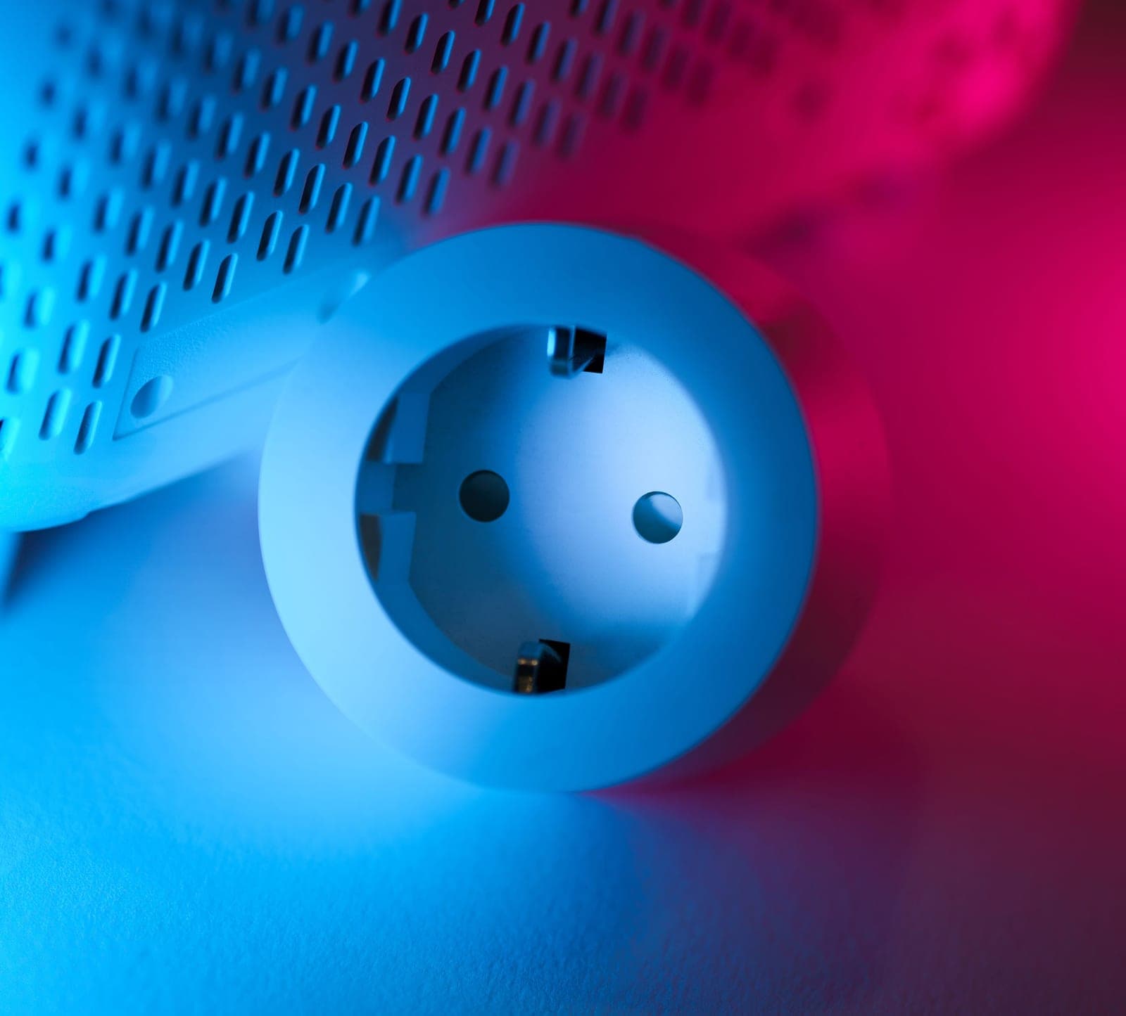 A digital plug-in timer connected to a wall socket
