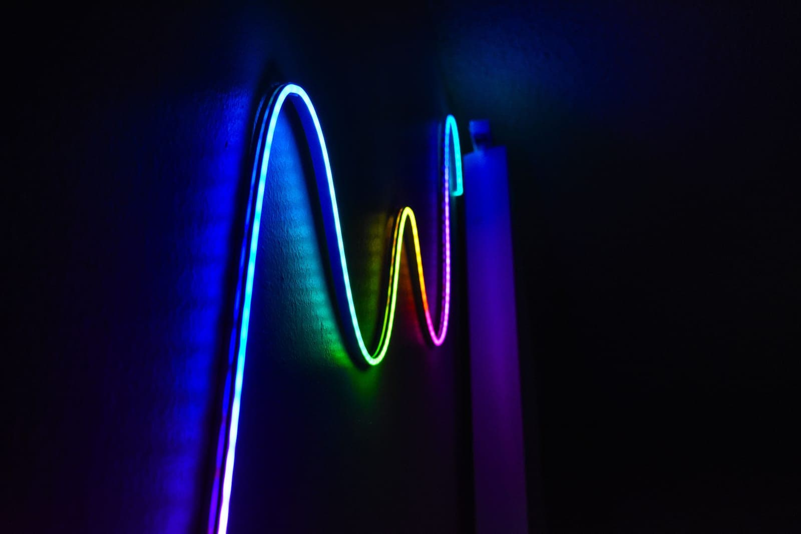 An LED light strip glowing against a dark background