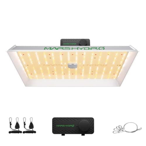 A flat white-light LED grow panel suspended above a tray of young plants on a wire rack
